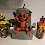 Pop culture and movie merchandise have always gone hand in hand, with fans eager to collect anything "Baby Deadpool Popcorn Bucket"